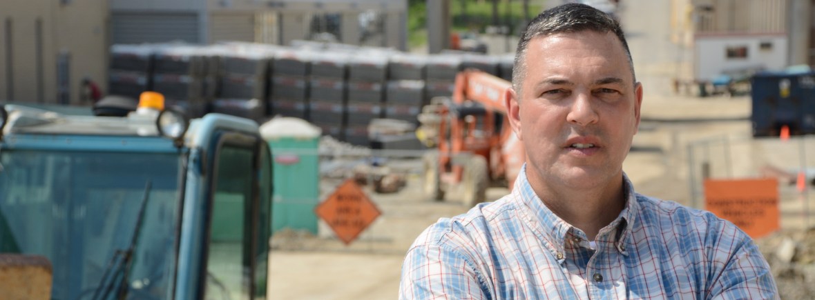John Lippl standing in front of construction site.